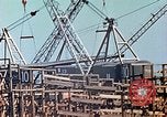 Image of Mobile cranes move ship's deck section at shipyard in World War California United States USA, 1942, second 25 stock footage video 65675025791