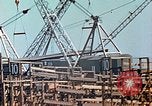 Image of Mobile cranes move ship's deck section at shipyard in World War California United States USA, 1942, second 26 stock footage video 65675025791
