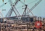 Image of Mobile cranes move ship's deck section at shipyard in World War California United States USA, 1942, second 27 stock footage video 65675025791