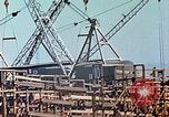 Image of Mobile cranes move ship's deck section at shipyard in World War California United States USA, 1942, second 28 stock footage video 65675025791