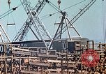 Image of Mobile cranes move ship's deck section at shipyard in World War California United States USA, 1942, second 29 stock footage video 65675025791
