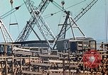 Image of Mobile cranes move ship's deck section at shipyard in World War California United States USA, 1942, second 30 stock footage video 65675025791