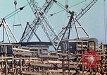 Image of Mobile cranes move ship's deck section at shipyard in World War California United States USA, 1942, second 32 stock footage video 65675025791