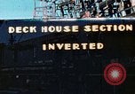 Image of Work being done on inverted deck house section of a Liberty ship  California United States USA, 1942, second 1 stock footage video 65675025793