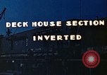 Image of Work being done on inverted deck house section of a Liberty ship  California United States USA, 1942, second 4 stock footage video 65675025793