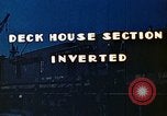 Image of Work being done on inverted deck house section of a Liberty ship  California United States USA, 1942, second 5 stock footage video 65675025793