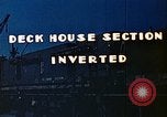 Image of Work being done on inverted deck house section of a Liberty ship  California United States USA, 1942, second 6 stock footage video 65675025793