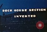 Image of Work being done on inverted deck house section of a Liberty ship  California United States USA, 1942, second 7 stock footage video 65675025793