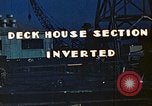 Image of Work being done on inverted deck house section of a Liberty ship  California United States USA, 1942, second 9 stock footage video 65675025793