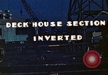 Image of Work being done on inverted deck house section of a Liberty ship  California United States USA, 1942, second 10 stock footage video 65675025793