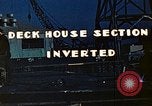 Image of Work being done on inverted deck house section of a Liberty ship  California United States USA, 1942, second 11 stock footage video 65675025793