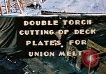 Image of Double torch cutting deck plates for Liberty ship under construction California United States USA, 1942, second 1 stock footage video 65675025804