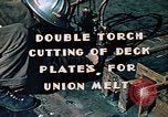 Image of Double torch cutting deck plates for Liberty ship under construction California United States USA, 1942, second 3 stock footage video 65675025804