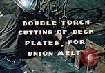 Image of Double torch cutting deck plates for Liberty ship under construction California United States USA, 1942, second 4 stock footage video 65675025804