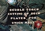 Image of Double torch cutting deck plates for Liberty ship under construction California United States USA, 1942, second 5 stock footage video 65675025804