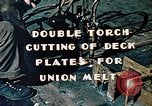 Image of Double torch cutting deck plates for Liberty ship under construction California United States USA, 1942, second 6 stock footage video 65675025804
