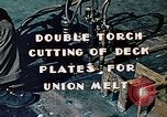 Image of Double torch cutting deck plates for Liberty ship under construction California United States USA, 1942, second 7 stock footage video 65675025804