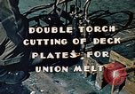 Image of Double torch cutting deck plates for Liberty ship under construction California United States USA, 1942, second 8 stock footage video 65675025804