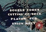 Image of Double torch cutting deck plates for Liberty ship under construction California United States USA, 1942, second 9 stock footage video 65675025804