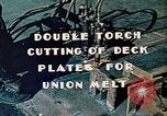 Image of Double torch cutting deck plates for Liberty ship under construction California United States USA, 1942, second 10 stock footage video 65675025804