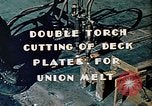 Image of Double torch cutting deck plates for Liberty ship under construction California United States USA, 1942, second 11 stock footage video 65675025804