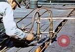 Image of Double torch cutting deck plates for Liberty ship under construction California United States USA, 1942, second 51 stock footage video 65675025804