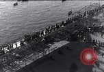 Image of Sightseers look at zeppelin wreckage displayed on dock  Salonica Greece, 1916, second 25 stock footage video 65675025842