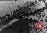 Image of Sightseers look at zeppelin wreckage displayed on dock  Salonica Greece, 1916, second 30 stock footage video 65675025842