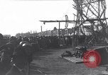 Image of Sightseers look at zeppelin wreckage displayed on dock  Salonica Greece, 1916, second 34 stock footage video 65675025842