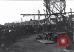 Image of Sightseers look at zeppelin wreckage displayed on dock  Salonica Greece, 1916, second 37 stock footage video 65675025842