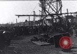 Image of Sightseers look at zeppelin wreckage displayed on dock  Salonica Greece, 1916, second 39 stock footage video 65675025842