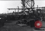 Image of Sightseers look at zeppelin wreckage displayed on dock  Salonica Greece, 1916, second 40 stock footage video 65675025842