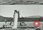Image of women bathers sliding headfirst down a slide into a lake United States USA, 1940, second 6 stock footage video 65675026047