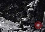 Image of Fallen Japanese soldiers among rocks Iwo Jima, 1945, second 18 stock footage video 65675026273