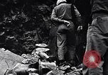 Image of Fallen Japanese soldiers among rocks Iwo Jima, 1945, second 20 stock footage video 65675026273