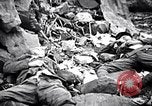 Image of Fallen Japanese soldiers among rocks Iwo Jima, 1945, second 28 stock footage video 65675026273