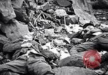 Image of Fallen Japanese soldiers among rocks Iwo Jima, 1945, second 29 stock footage video 65675026273