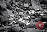Image of Fallen Japanese soldiers among rocks Iwo Jima, 1945, second 31 stock footage video 65675026273