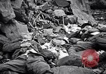 Image of Fallen Japanese soldiers among rocks Iwo Jima, 1945, second 32 stock footage video 65675026273