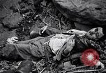 Image of Fallen Japanese soldiers among rocks Iwo Jima, 1945, second 38 stock footage video 65675026273