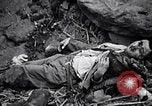 Image of Fallen Japanese soldiers among rocks Iwo Jima, 1945, second 40 stock footage video 65675026273