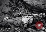 Image of Fallen Japanese soldiers among rocks Iwo Jima, 1945, second 41 stock footage video 65675026273