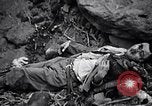 Image of Fallen Japanese soldiers among rocks Iwo Jima, 1945, second 42 stock footage video 65675026273