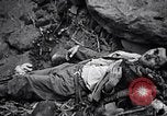 Image of Fallen Japanese soldiers among rocks Iwo Jima, 1945, second 43 stock footage video 65675026273