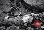 Image of Fallen Japanese soldiers among rocks Iwo Jima, 1945, second 44 stock footage video 65675026273