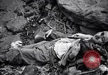 Image of Fallen Japanese soldiers among rocks Iwo Jima, 1945, second 46 stock footage video 65675026273