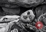 Image of Fallen Japanese soldiers among rocks Iwo Jima, 1945, second 48 stock footage video 65675026273