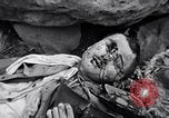 Image of Fallen Japanese soldiers among rocks Iwo Jima, 1945, second 49 stock footage video 65675026273