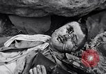 Image of Fallen Japanese soldiers among rocks Iwo Jima, 1945, second 52 stock footage video 65675026273