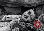 Image of Fallen Japanese soldiers among rocks Iwo Jima, 1945, second 53 stock footage video 65675026273